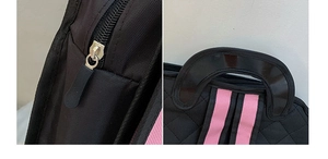 Detail of premium oxford fabric with pink strap and durable black hardware zippers