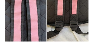 Detail of pink straps and adjustable plastic buckle on black quilted 2D cartoon backpack