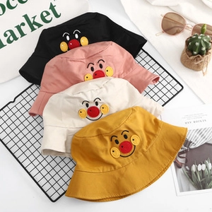 Detail showing colorful kids cotton sun hats with cute cartoon face embroidery