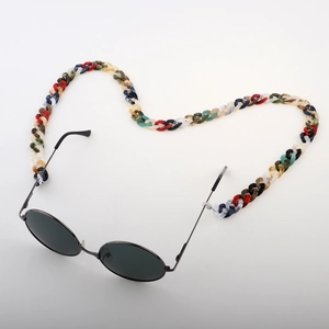 Macro shot of colorful acrylic eyeglass chain in heart shape with black round sunglasses
