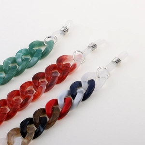 Close-up of three colorful acrylic eyewear chains in marble and tortoiseshell patterns
