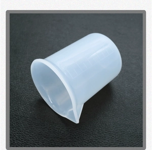 Detail view of 100ml silicone measuring cup with precise scale and pouring spout for DIY resin
