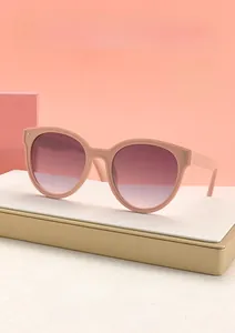 Close-up of pink round sunglasses frame featuring intricate woven texture on the temples