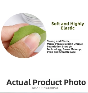 Detail of soft green makeup sponge showing fine pores and high resilience when squeezed