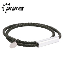 Detail of double-layer braided leather bracelet with silver magnetic clasp and round charm