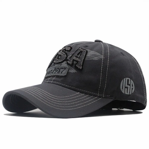 Detail of USA embroidery on washed denim baseball cap with vintage grey cotton fabric
