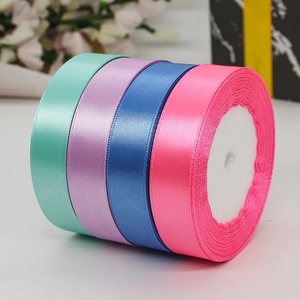 Rolls of 2cm colorful satin ribbons in green, purple, blue, and pink for gift wrapping