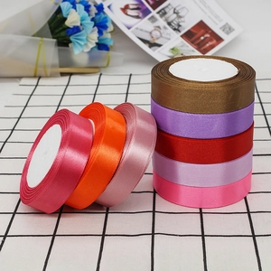 Macro shot of 2cm colorful satin ribbons rolls for gift wrapping and DIY crafts