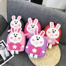 Close-up of colorful children's backpacks featuring 3D cartoon bunny designs and soft fabric