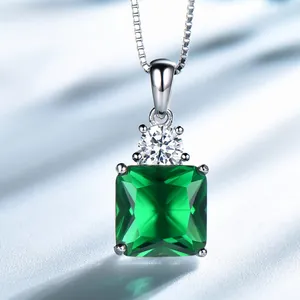 Macro detail of square emerald pendant with zircon accent on a silver chain