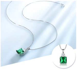 Close-up of square emerald pendant on silver box chain with macro detail view