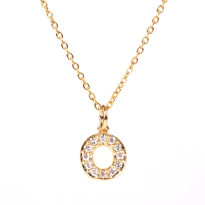 Macro shot of gold circle pendant necklace with pavé set white zircon stones