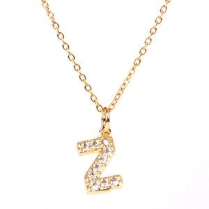 Detailed macro shot of a gold Z-letter pendant with sparkling crystal inlay on thin chain
