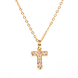 Macro shot of gold-plated initial T pendant necklace with sparkling micro-pave crystals