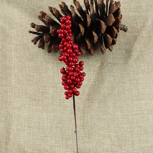 Artificial Christmas red berry stem for DIY floral decor on rustic burlap backdrop