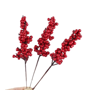 Three vibrant red artificial berry branches for Christmas decor and DIY floral arrangements