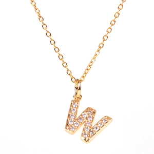 Detailed close-up of capital letter W pendant with sparkling pavé crystals on gold chain