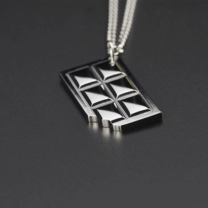 Polished silver titanium steel chocolate bar pendant necklace with bite mark detail
