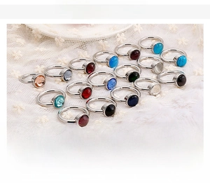 Macro shot of stainless steel rings featuring colorful cat's eye and crystal stones