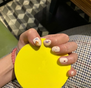 Artistic press-on nails with colorful abstract face lines and geometric patterns