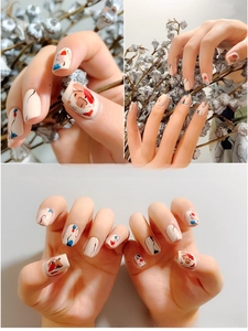 Detail of 3D nail stickers featuring abstract face line art and modern color blocks