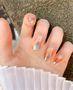 Detail of 3D nail stickers with abstract colorful patterns and silver metallic French tips