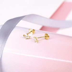 Detailed macro view of S925 sterling silver gold-plated marquise-cut leaf stud earrings