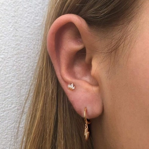 Close-up of S925 sterling silver crown stud and lightning drop earrings with cubic zirconia