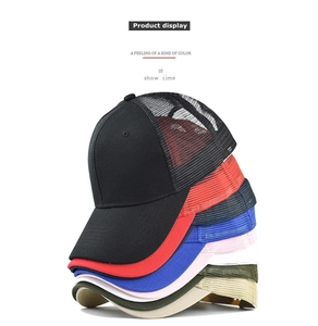 Stacked collection of breathable mesh trucker hats in various colors with curved brims