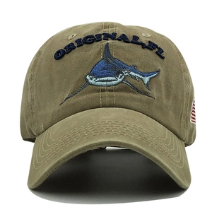 Close-up of khaki cotton baseball cap featuring blue shark embroidery and curved brim