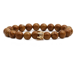 Brown wooden bead bracelet with a gold-plated crown charm on a clean white background