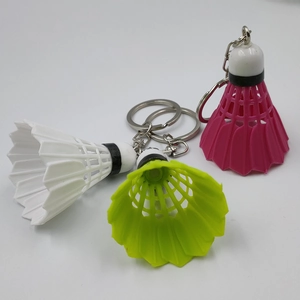 Miniature shuttlecock keychains in white, neon green, and pink for sports fans