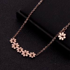Elegant rose gold daisy flower tassel necklace in titanium steel on a black display box