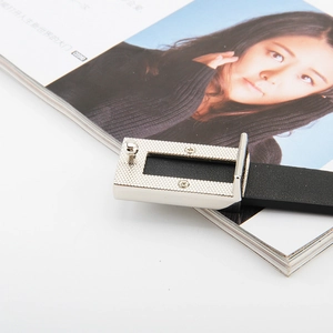 Slim black leather belt with silver textured rectangle buckle for jeans and dresses