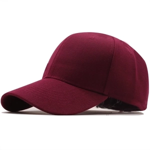 Side view detail of a burgundy cotton baseball cap showing twill texture and six-panel design