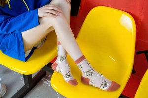 Detail of ultra-thin transparent mesh socks with cat patterns and contrast heels