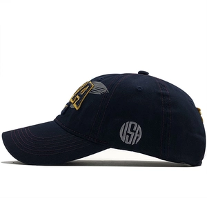 Detailed side view of navy cotton baseball cap with grey USA embroidery and gold eagle patch