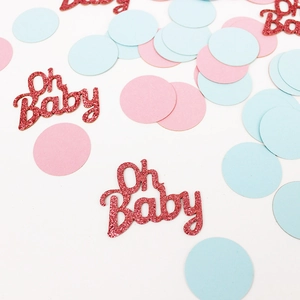 Pink and blue baby shower confetti with glittering Oh Baby decorative cutouts on white background
