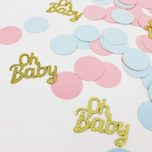 Detail of pink and blue baby shower confetti with gold glitter Oh Baby cutout decorations