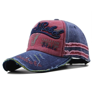 Close-up of Rock Rebel 3D embroidery on vintage washed red and blue baseball cap