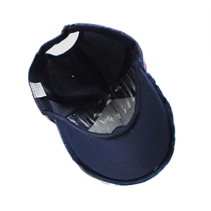 Navy blue cotton baseball cap interior view with adjustable strap and 100% cotton label