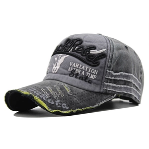 Detail of Rock Rebel embroidery and frayed edges on washed grey vintage baseball cap