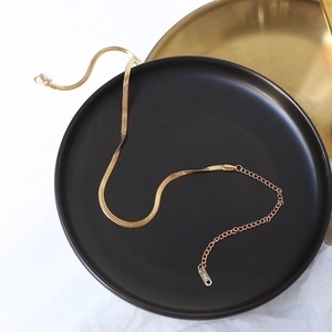 Elegant 18K gold plated snake chain choker with adjustable clasp on a black matte display