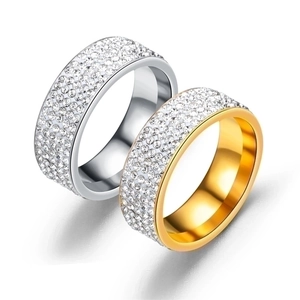 Five-row crystal inlaid titanium steel rings in gold and silver finish on white background
