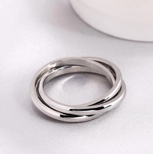 Stainless steel triple interlocking spinning ring with sun moon stars pattern on grey background