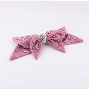 Pink velvet bow hair clip with sparkling rhinestones and crystal stones on white background