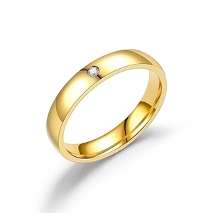 Minimalist gold titanium steel ring with round diamond inlay on white background