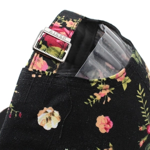 Women's black floral baseball cap with rose print and adjustable metal back buckle
