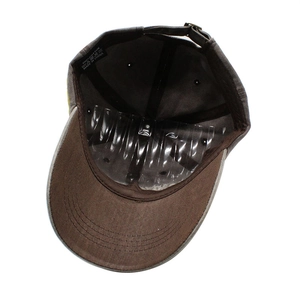 Detail view of cotton baseball cap interior featuring a 100% cotton label and metal buckle