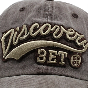 Close-up of 3D embroidery and washed cotton texture on a vintage 3ET baseball cap